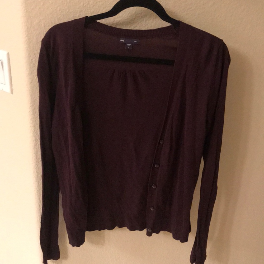 A purple/mauve button down sweater